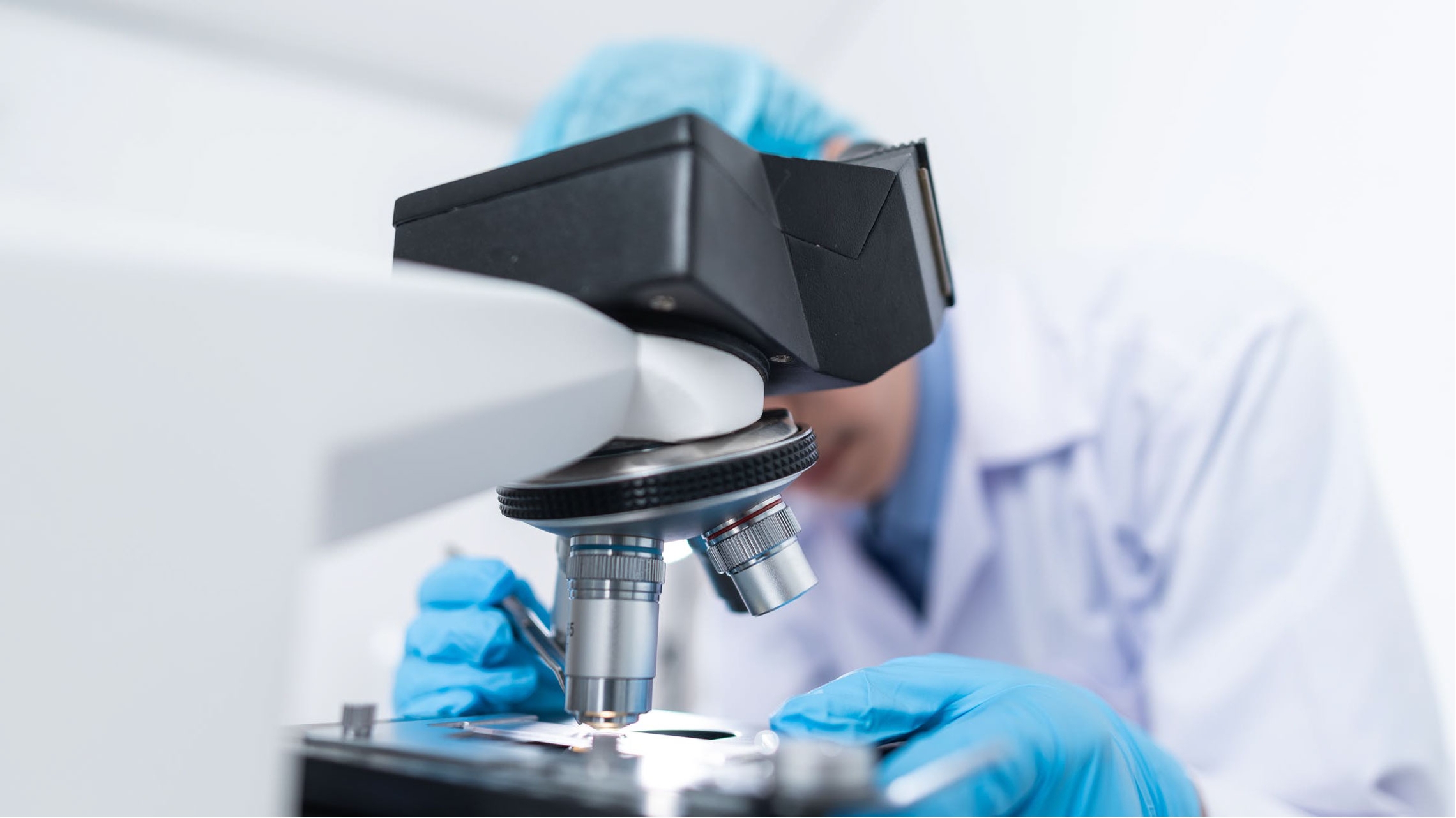 Man looking through microscope 